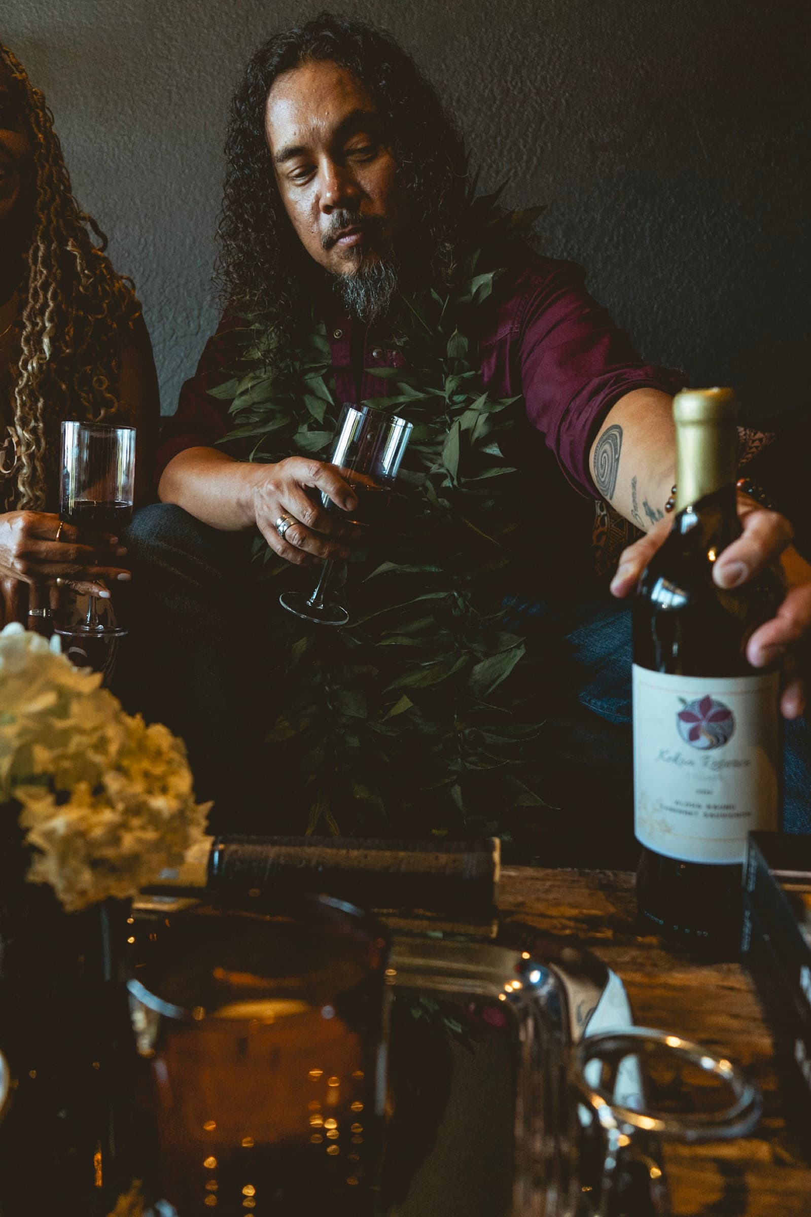 Koa Kekoa sharing wine around the table